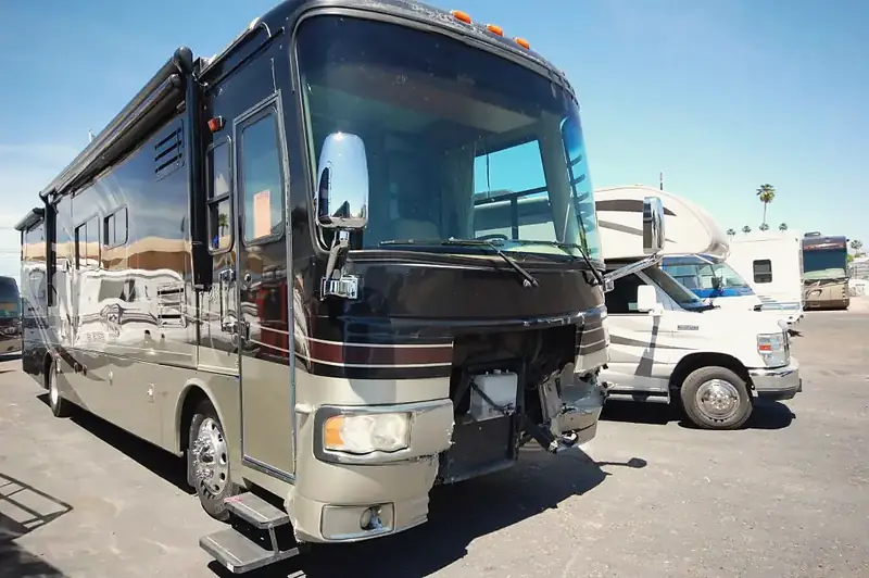 Class A motorhome with its front cap and bumper torn away