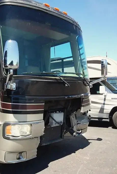 Class A motorhome as it came in, with its front cap and bumper torn away